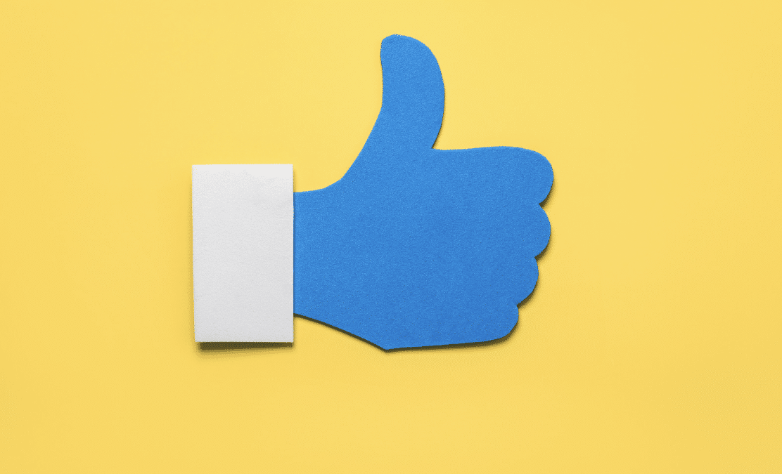 social media like icon in blue on yellow background